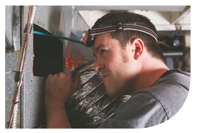 Man Inspecting Ductwork