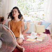 girl cool off with a fan