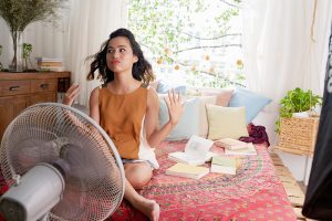 girl cool off with a fan