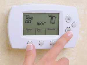 adjusting thermostat in your home